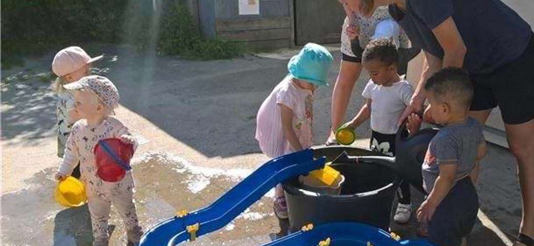 Børn og voksne leger med vand. Det er altid sjovt.