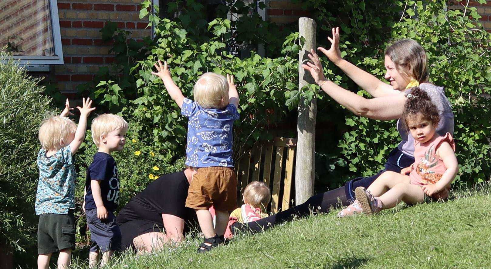 Leg med hænderne - hvor højt kan man strække sig? Nogle gange er børnene i små grupper. Andre gange er de sammen med flere børn.